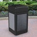 A black rectangular Commercial Zone StoneTec waste receptacle with black and grey panels on a brick surface.