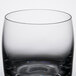 A close up of a Libbey Symmetry Rocks glass with a black rim.