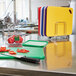 A Rubbermaid stainless steel cutting board rack holding 7 cutting boards on a counter.
