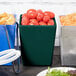 A Tablecraft hunter green bowl filled with tomatoes on a table in a salad bar.