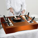 A chef cooking food on a Tablecraft copper induction station.