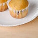 Two cupcakes on a Choice white uncoated paper plate.