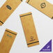 A group of rectangular wooden Choice menu holders with black straps.