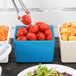 A blue square Tablecraft bowl with tomatoes in it.