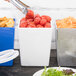 A Tablecraft white square bowl filled with tomatoes and other food items.