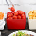 A Tablecraft red straight sided bowl filled with tomatoes.