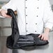 A chef holding a Victorinox carrying case with knives.