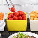 A yellow Tablecraft straight sided bowl filled with tomatoes.