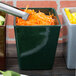 A person cutting carrots into a Tablecraft Hunter Green and White Speckle bowl.