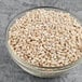 A bowl of Dried Whole Pearl Barley on a table.