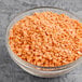 A bowl of dried red lentils.