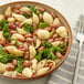 A bowl of pasta with cranberry beans and kale.