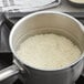 A pot of Organic White Basmati Rice cooking on a stove.