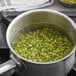 A pot of green split peas being cooked.