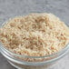 A bowl of white long grain rice on a table.