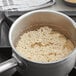 A pot of Organic White Long Grain Rice cooking on a stove.