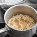 A pot of brown basmati rice cooking on a stove.