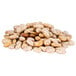 A pile of organic dried pinto beans on a white background.