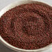 A white bowl of Regal red quinoa on a table.