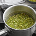 A pot of green peas being cooked.