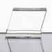 A clear glass stand on a table with a clear surface holding a Manitowoc remote condenser.