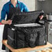 A black heavy-duty insulated soft-sided food delivery bag designed to hold six 2 1/2-inch deep full size food pans.