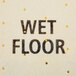 A yellow Rubbermaid Over-The-Spill absorbent pad with a wet floor sign in the background.