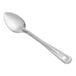 A Vollrath stainless steel basting spoon with a handle on a white background.