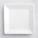 An Acopa bright white square porcelain plate with a white rim.