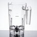 A clear plastic container with a handle for a Waring commercial blender.