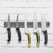 A group of knives on a Dexter-Russell magnetic strip.