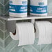 A set of Lavex Premium individually wrapped 2-ply standard toilet paper rolls, with two rolls on a dispenser and two wrapped rolls on a shelf above.