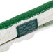 A green and white Unger ThePad cleaning pad with a label on it.