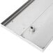 A close-up of a stainless steel Advance Tabco bar drink rail.