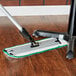 A 3M green wet mop pad on a wood floor.