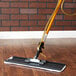 A 3M Easy Shine mop being used on a wood floor.