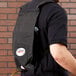 A man using a 3M Easy Shine applicator system on his back.