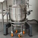 A stainless steel Avantco mixer pot sitting on rubber feet.