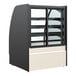 A black Structural Concepts refrigerated bakery display case with curved glass.