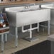 A Regency stainless steel underbar sink with a left drainboard on a counter.