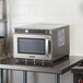 A Solwave heavy-duty commercial microwave on a table.