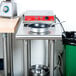 An Advance Tabco stainless steel filler table with a backsplash and undershelf.