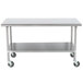 A stainless steel table with wheels.