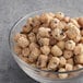 A bowl of chocolate chip cookie dough topping on a table.