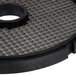 A black circular Hobart Dicing Grid with a hole in the center on a metal grid.
