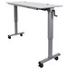 A grey rectangular Luxor adjustable height desk with wheels.