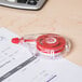 A Universal correction tape dispenser on paper.