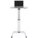 A white Luxor pneumatic adjustable height lectern with a laptop on it.