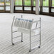A white metal Luxor charging cart with tablets on it.