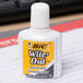 A white Bic Wite-Out bottle on a desk.